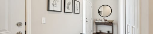 Entry hallway with two benches and a mirror and a door