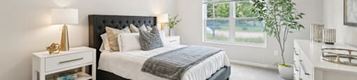 spacious bedroom with a bed  and a big window