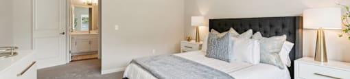 a bedroom with a bed and a ceiling fan