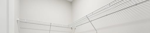 a spacious closet in a home with white walls and a white door