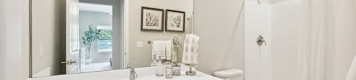 ensuite bathroom with a large mirror and walk-in shower