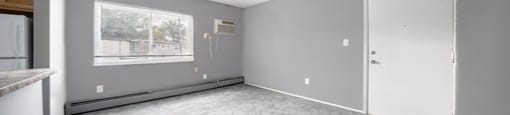 a living room with gray walls and a white door
