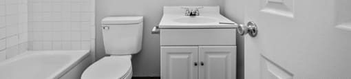 a bathroom with a sink toilet and a bath tub