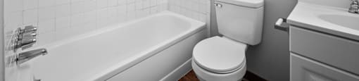 an empty bathroom with a toilet and a bath tub