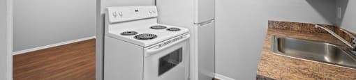 a kitchen with a stove refrigerator and a sink