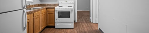 a kitchen with white appliances and wooden cabinets