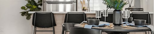 a kitchen and dining area with a table and chairs