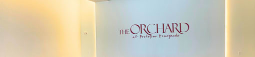 a lobby with a blue couch and a sign for the orchid