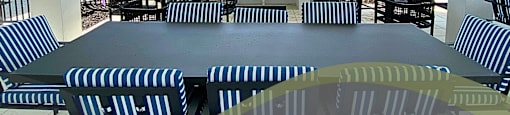 a large patio with tables and chairs and a bar