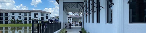 a view of a building with a walkway next to a pool