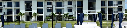a large swimming pool in front of an apartment building