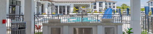 A patio with a table and chairs overlooking a pool at Portofino Vineyards, Fort Myers