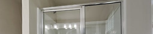 A white bathroom with a glass shower door.