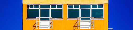 The building is tall, orange, and a great place to live.
