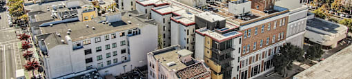 A cityscape with buildings of various designs and colors.