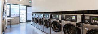 a laundromat with a bunch of machines in it