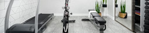 a home gym with a treadmill and exercise bike