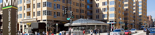 a rendering of a large apartment building on a city street