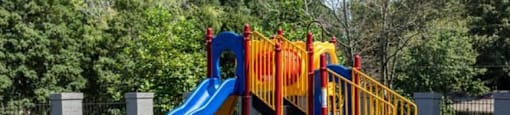 a playground with two slides and a green slide