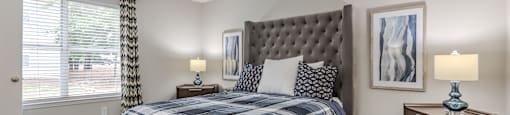 the master bedroom has a comfy bed and a large window