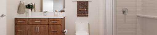 A white bathroom with a wooden cabinet and a white toilet.at The Landing at Hub City, Wisconsin, 53073