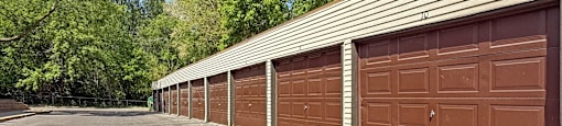 A row of brown garage doors are closed.