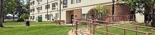 A building with a red railing in front of it.