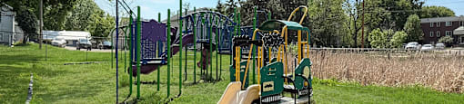 A playground with a slide and swings.