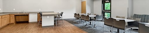 A conference room with a long table and chairs.