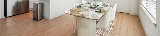 A kitchen with a table set for a meal.