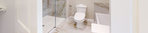 a bathroom with a toilet and a glass shower