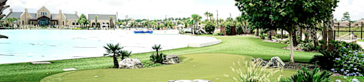 a putting green with a lake in the background