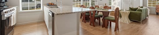 A modern kitchen with a dining table and chairs.