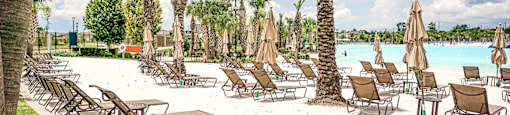 a beach with lounge chairs and umbrellas