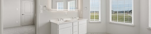 A bathroom with a marble floor and white walls.