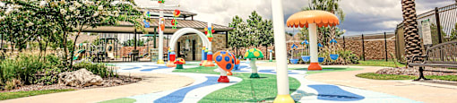 a playground with a palm tree and other play equipment