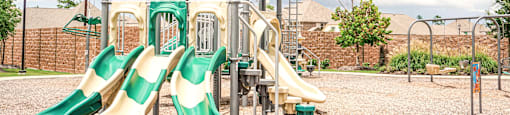 a playground with a climbing structure and slides
