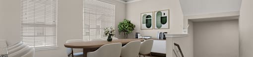 A dining room with a table and chairs.