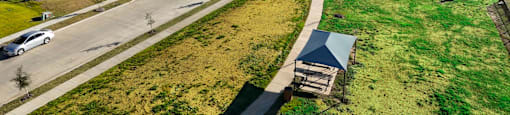 A suburban neighborhood with houses and a road.