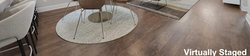 A modern dining room with a round table and chairs.