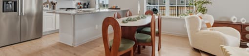 A modern kitchen with a dining table and chairs.