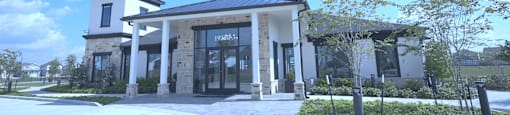 A modern building with a glass entrance and a covered walkway.