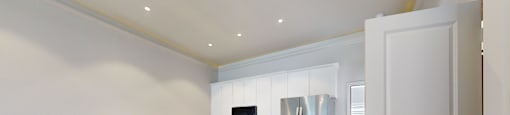 A kitchen with a white counter and a sink.