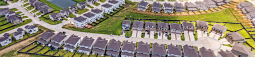 A bird's eye view of a residential area with houses arranged in a circular pattern.