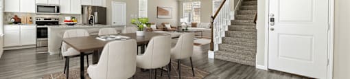 A modern kitchen with a dining table and chairs.