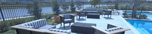 A black outdoor table and chairs are set up on a patio.