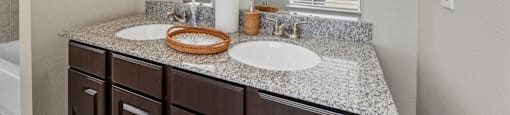 A bathroom with a large mirror above a double sink vanity.
