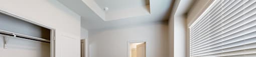 A room with a carpeted floor and a sliding door.