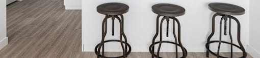 a kitchen with a island and three stools