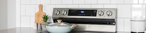 a white kitchen with a stove and a microwave